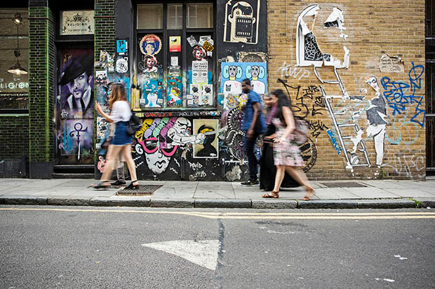 Students walking by graffiti