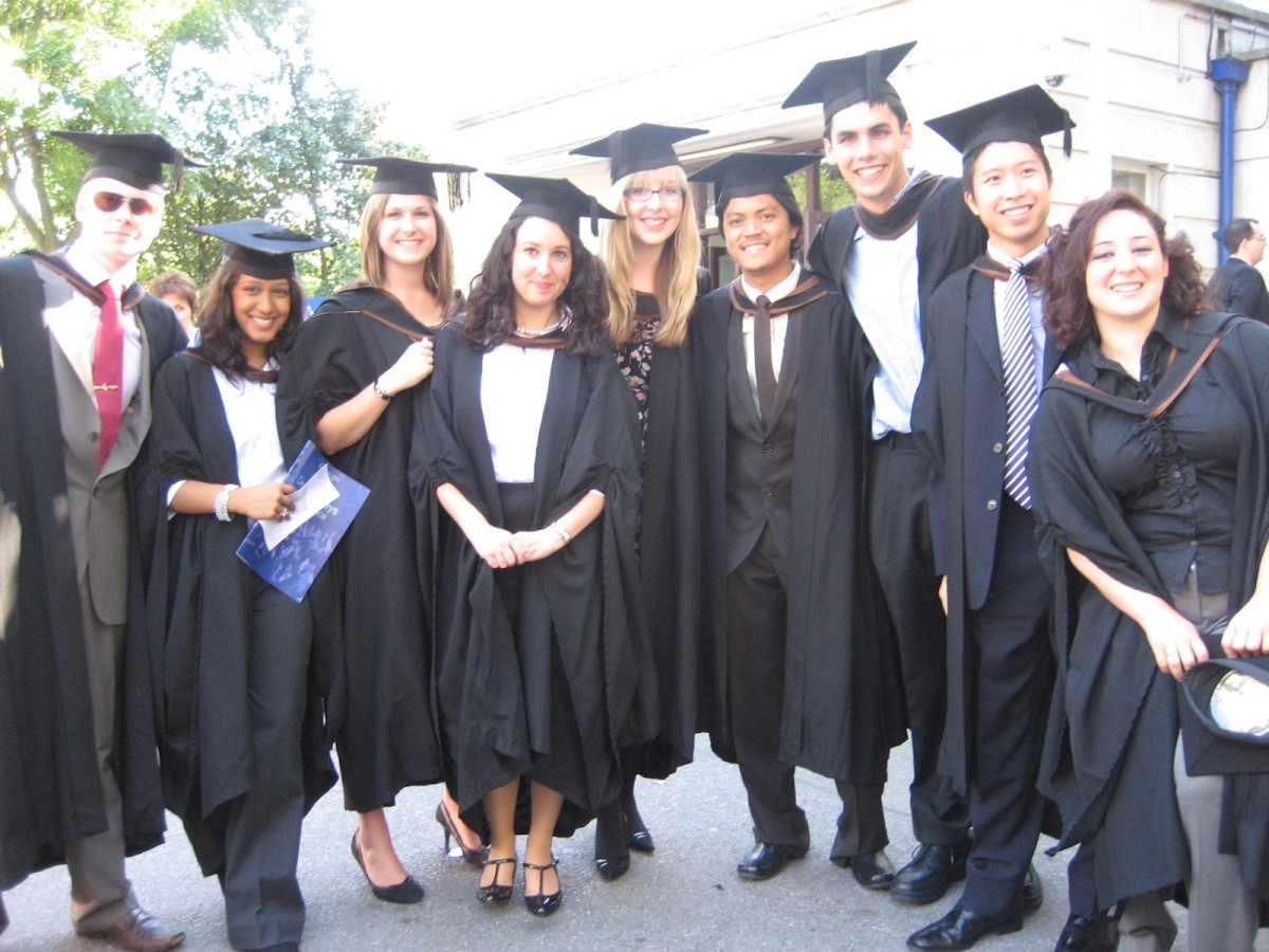 Photo of alumnus, Kamran Khan, surrounded by friends at his graduation ceremony