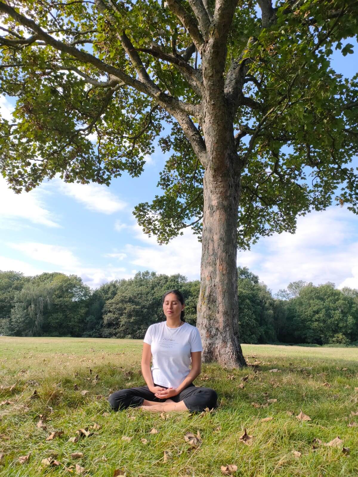 Alumna Maria Mercado seated in a yoga position