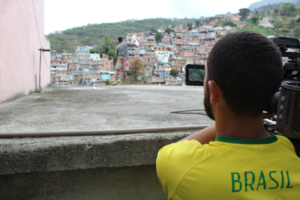 Photo of alumnus, Matt Kay, filming in a favela in Brazil