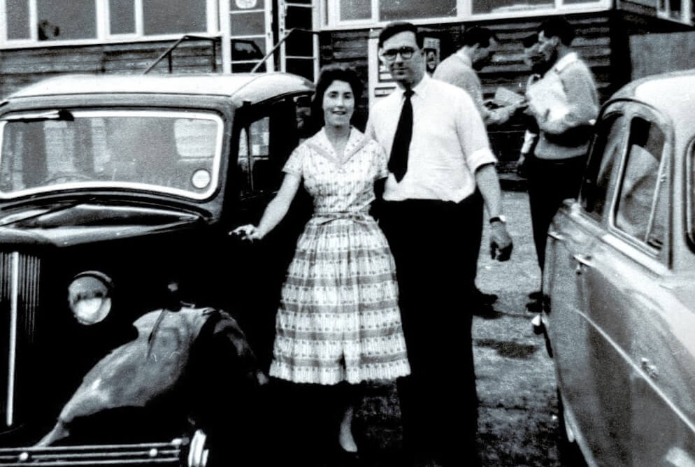 Black and white photo of alumnus Roger Clarke arm in arm with his wife Joan Clarke.