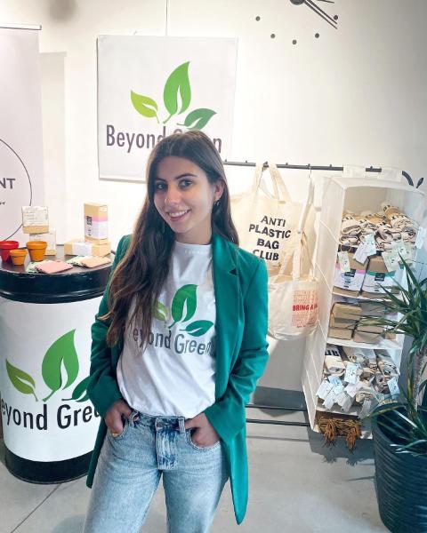 Photo of alumna, Teona Mango, with her Beyond Green merchandise