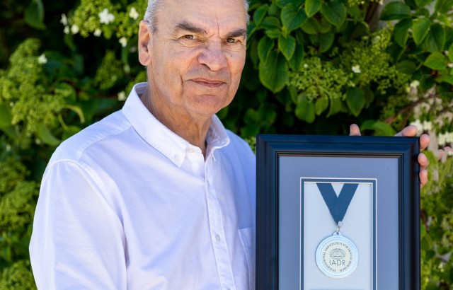 Professor David Williams holding the IADR Gold Medal Award