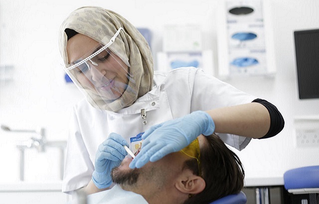 Dentist examining patient in The Royal London Dental Hospital