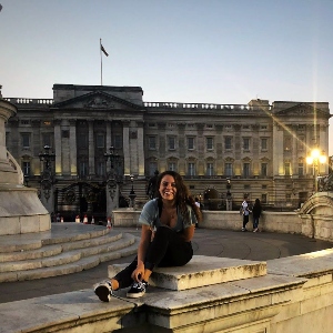 Student sitting outside Buckingham Palace