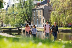Students walking by Regents Canal Mile End campus