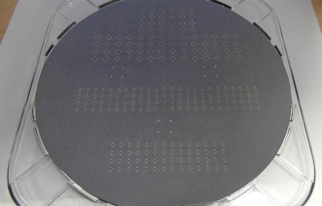 8-inch diameter graphene wafer with device test structures visible on the surface
