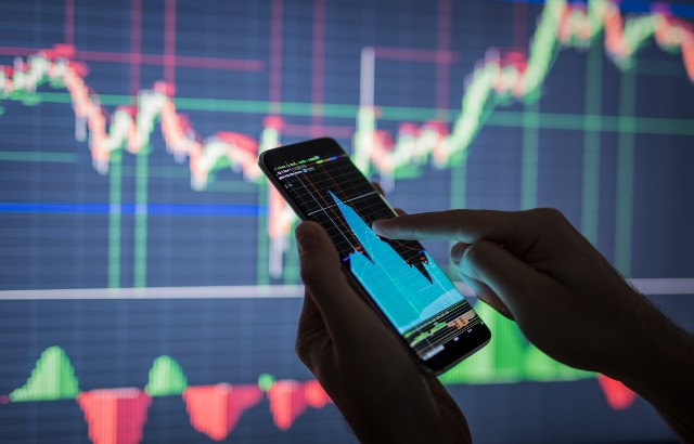 A person checking stock market data on a smartphone