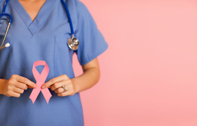 Doctor holding cancer ribbon 