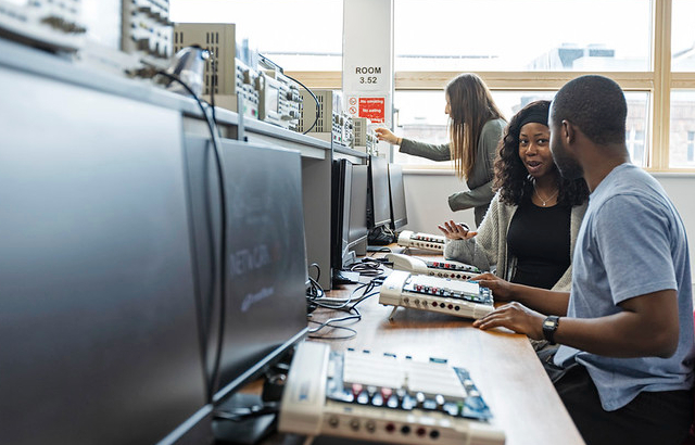 Image of students sitting in front of computers in a lab
