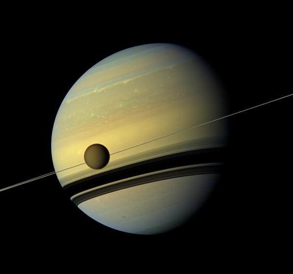 A giant of a moon appears before a giant of a planet undergoing seasonal changes in this natural color view of Titan and Saturn from NASA's Cassini spacecraft.Credit: NASA/JPL-Caltech/Space Science Institute