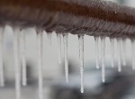 Icicles hanging from a pipe. Credit: Besjunior/iStock.com.