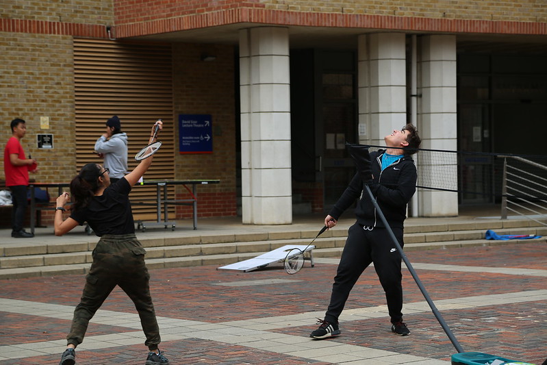 Students playing sports in library square