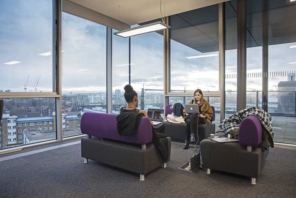 Students studying at the Graduate Centre with a rooftop view if the city