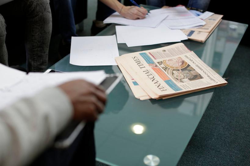 A table with documents and the Financial Times on it