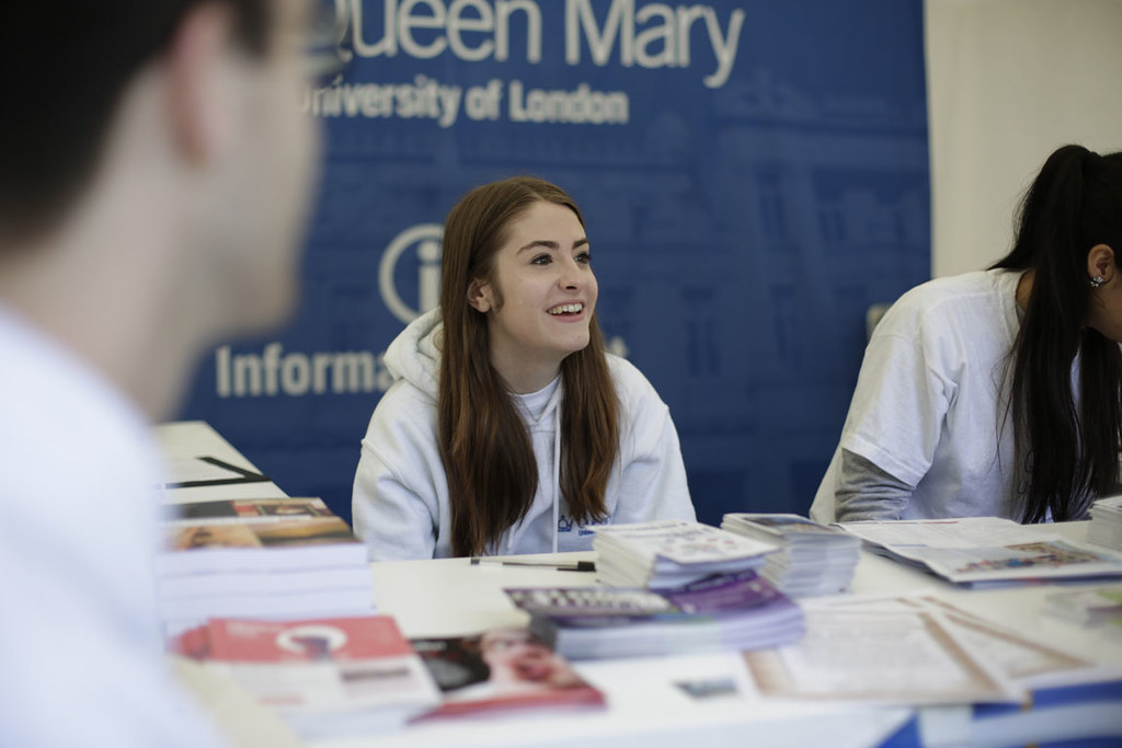 A Queen Mary staff member helping students