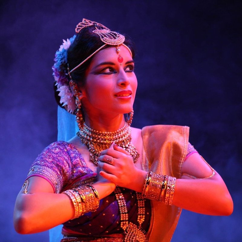 A woman in a sari dancing