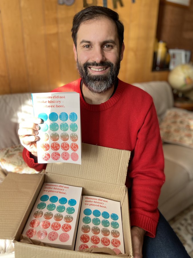 Dr Jon Kennedy with box of new books