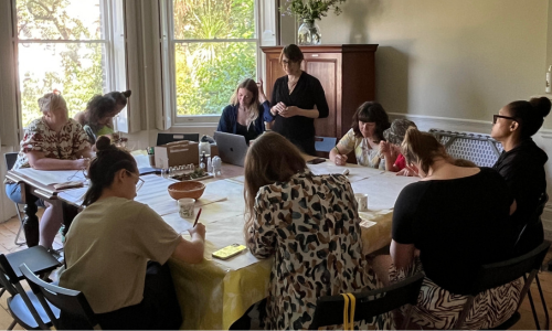 Workshop participants sitting around the table at the Magical Moss Plants workshop at the SLBI