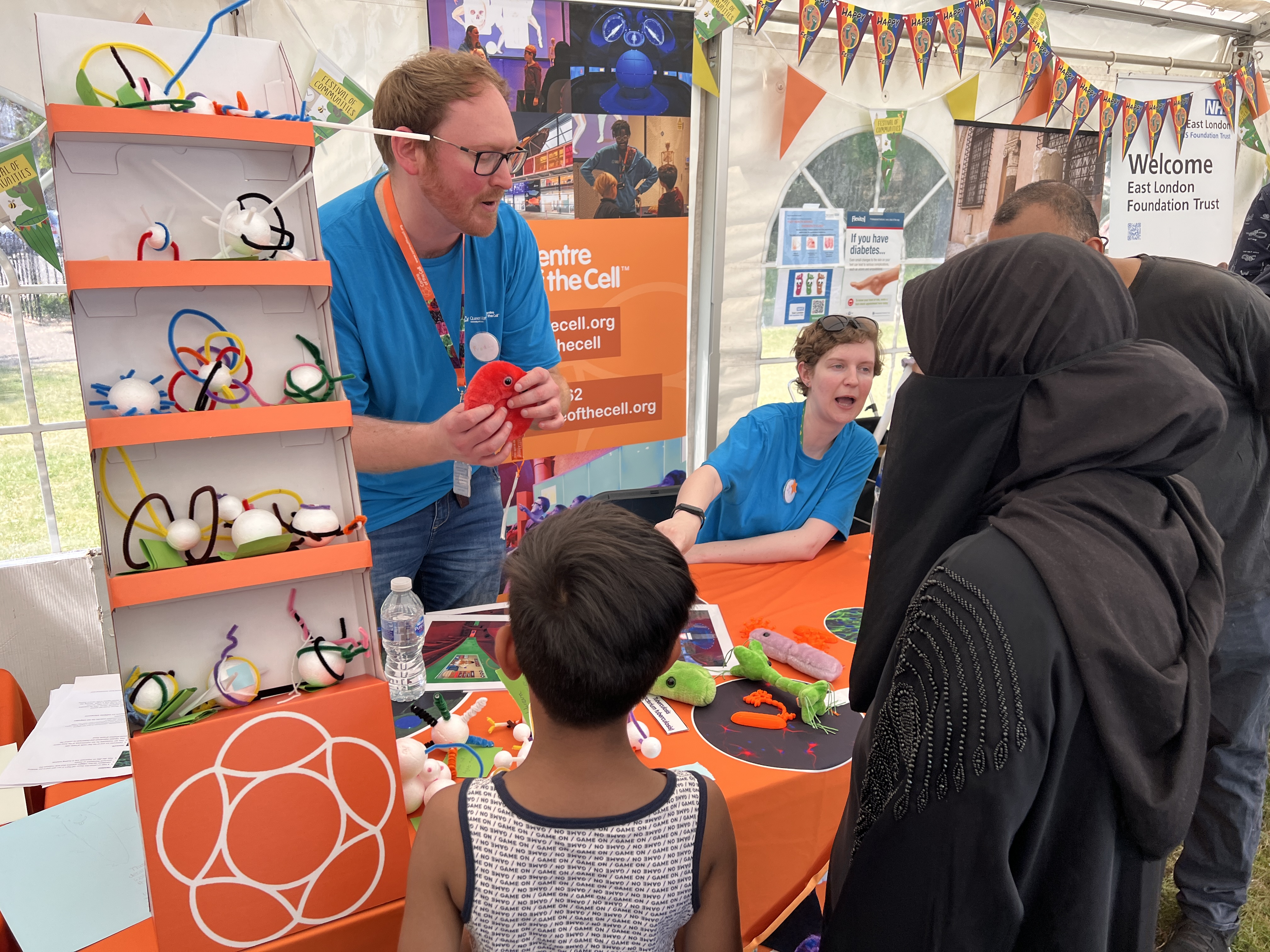 Staff from Centre of the Cell chat to visitors at the QMUL Festival of Communities