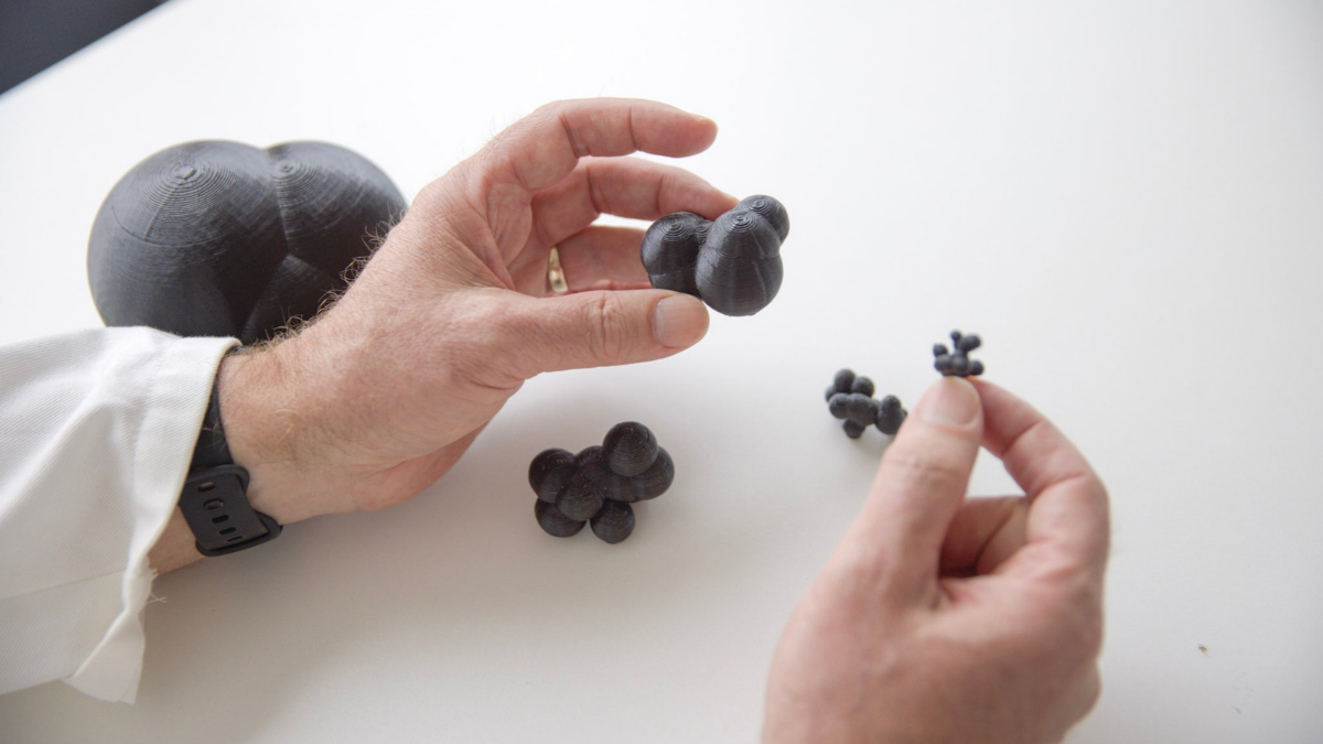 Hands holding different rubber parts that make up tyres