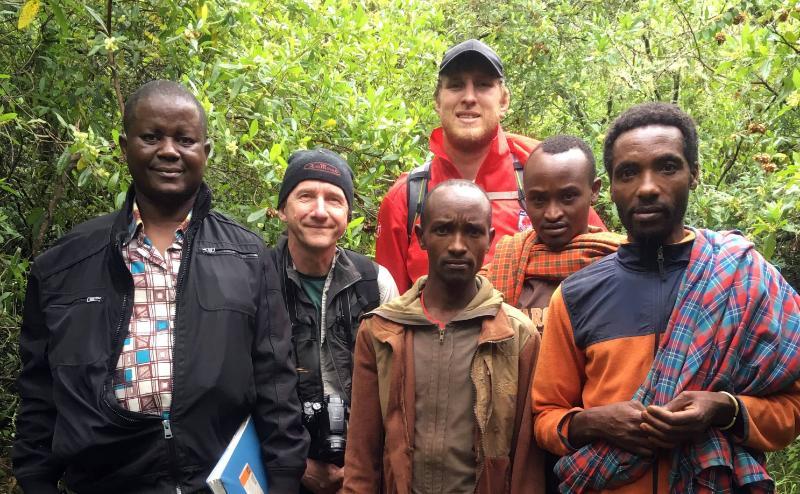 The team in the field: Dr Faulkes (with camera), Georgies Mgode (with notebook, co-author on the species description paper), Daniel Hart (in red) and three villagers from the Mt Hanang area