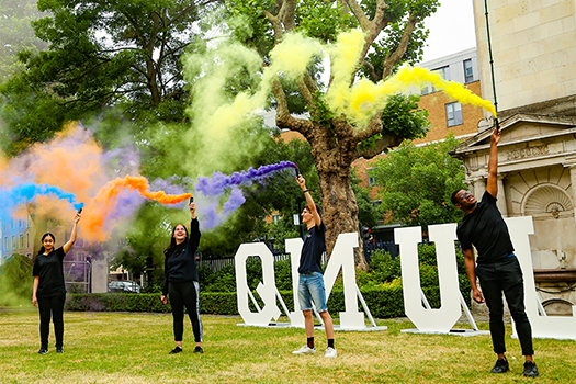 Students taking part in a display in front of the clock tower