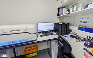 Genomics laboratory with machinery and petri dishes