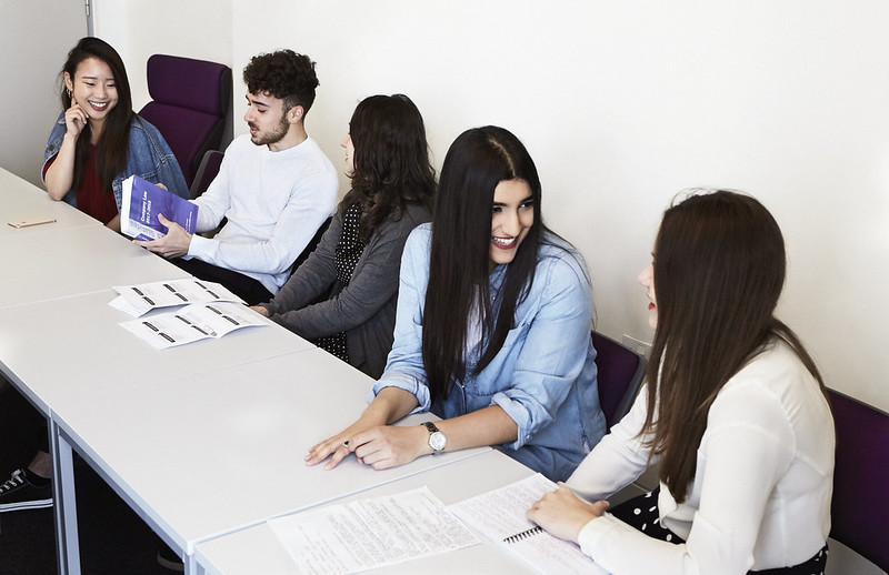 Students sitting in a row at a seminar table