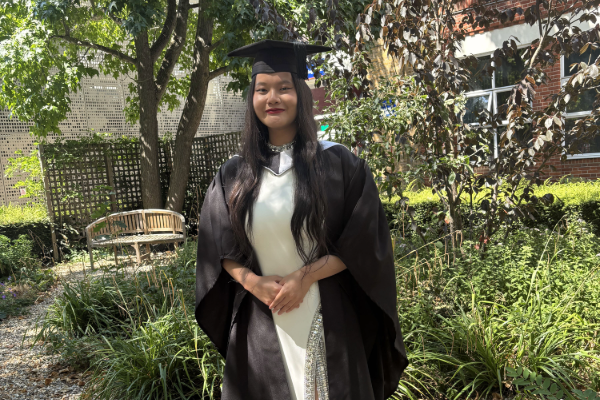 Lynda in graduation attire, smiling.