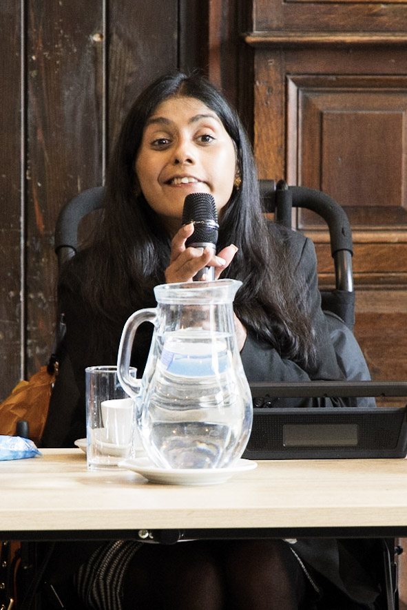 Photo of Bal Deol speaking at the Mile End Institute's event on 22 May. Bal is disabled and uses a wheelchair and is looking at the camera.