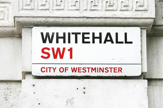 Photo of street sign on Whitehall showing the road name, postcode, and the CIty of Westminster logo to illustrate article about the UK constitution