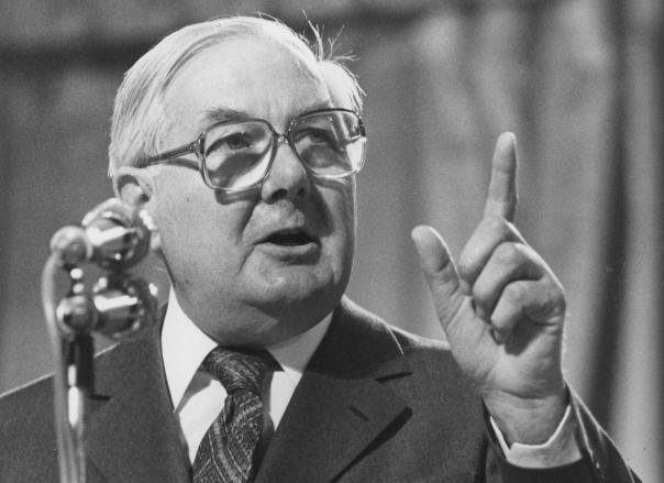 Photo of Jim Callaghan delivering a speech with one finger raised in the air.