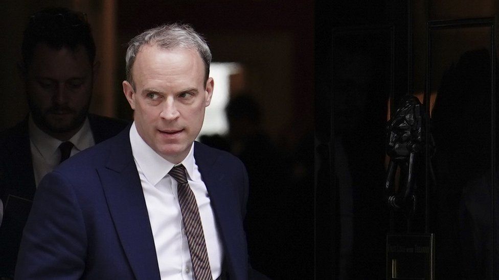 A BBC photo of Dominic Raab leaving Number 10 Downing Street. Raab looks particularly sinister, even by his own standards