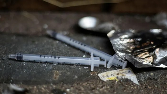 Photo of used needles on pavement in Glasgow to illustrate article about drugs policy