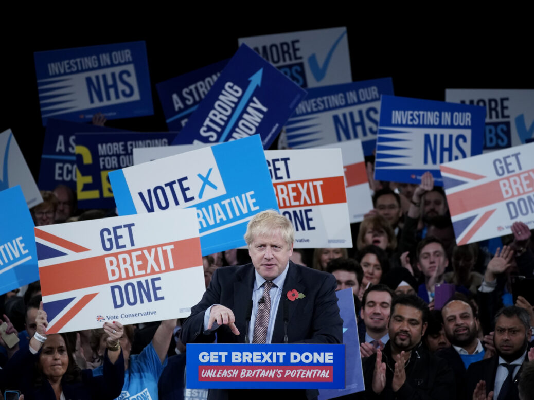 Boris Johnson in front of a crowd holding up 'Get Brexit Done' banners