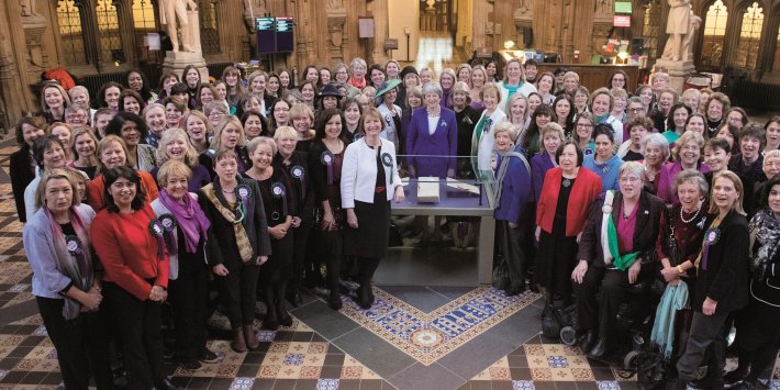 Photo of all women MPs in Parliament with then Prime Minister Theresa May