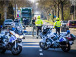 Two German policemen behind barriers stop the traffick