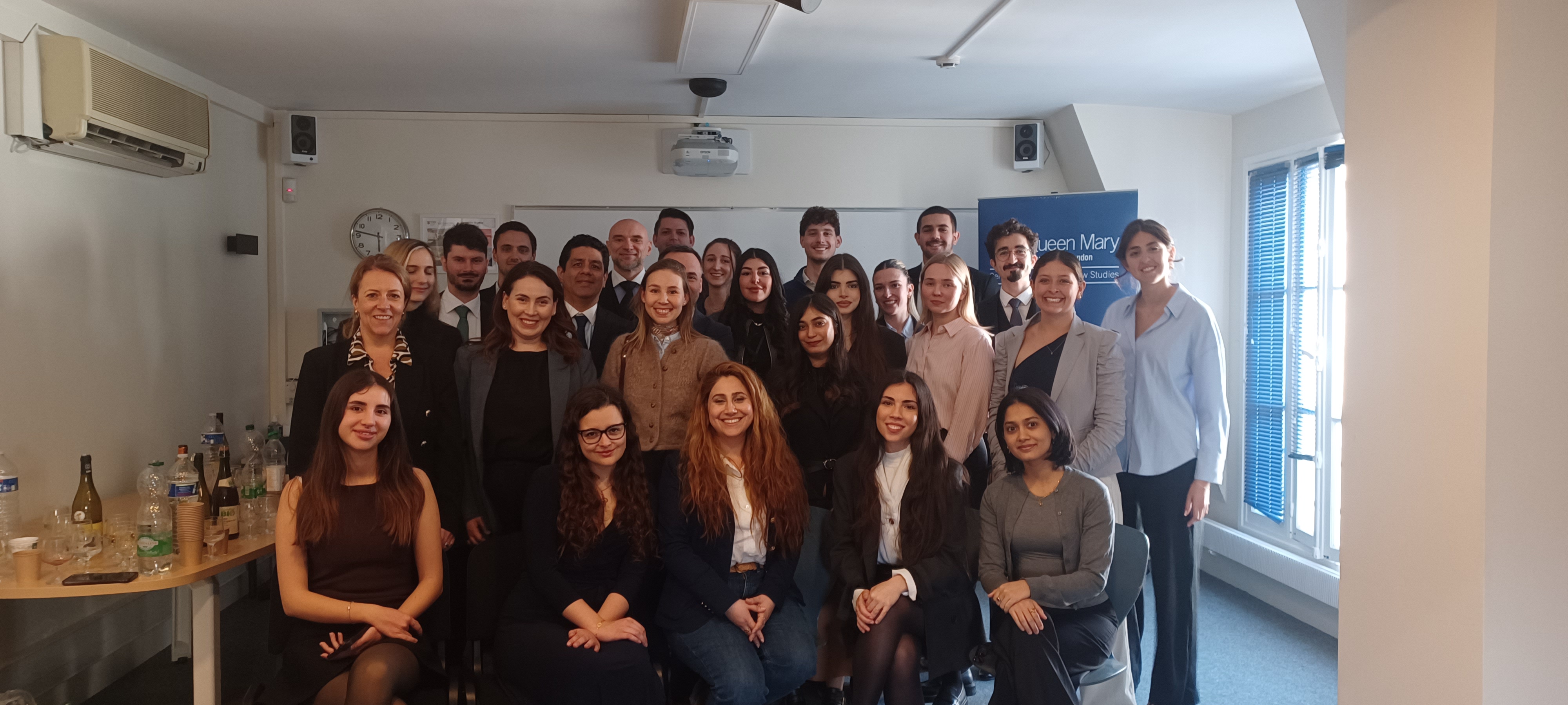 A group of students and academics smiling.