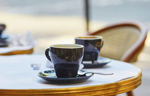 Two espresso cups on a table.