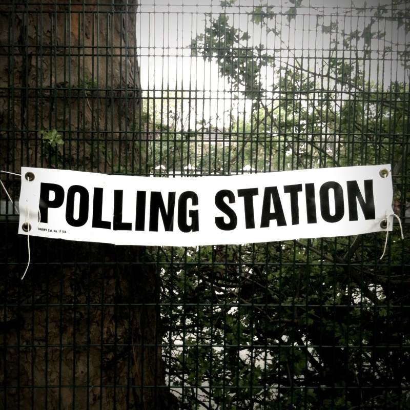polling station banner on railings