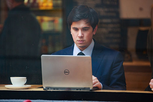 Student in cafe on laptop