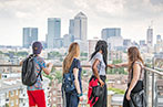 Queen Mary students with their back to the camera looking at Canary Warf