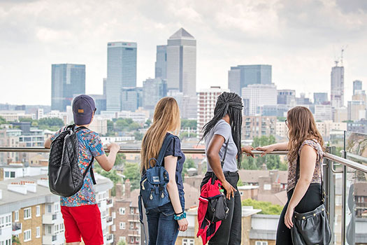 Queen Mary students with their back to the camera looking at Canary Warf