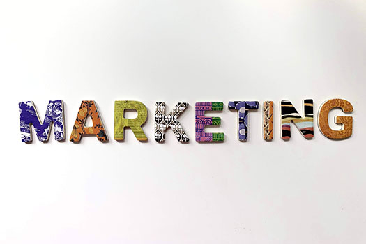 The word 'Marketing' written out in capitals, with each letter a different colour and pattern