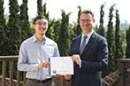 Cody Wong receiving his award for the essay prize from Professor Duncan Matthews