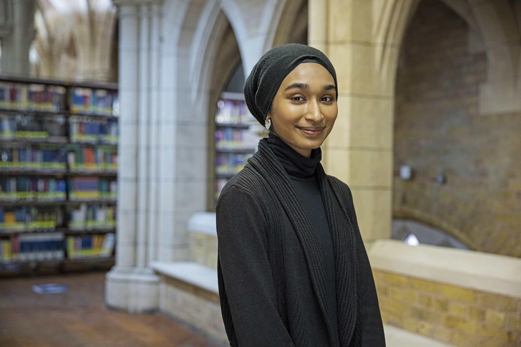 A student standing in the library at Whitechapel