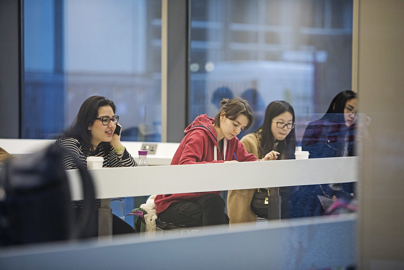 Students sitting at a counter in the Graduate Centre