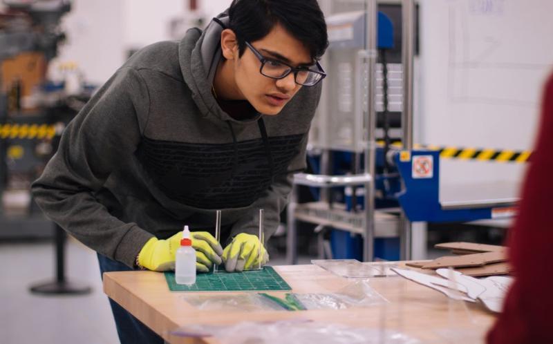 Image of an Engineering student at the bench in a workshop