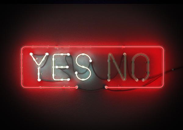 Yes or No sign made from neon alphabet on a black background. The Yes is illuminated.